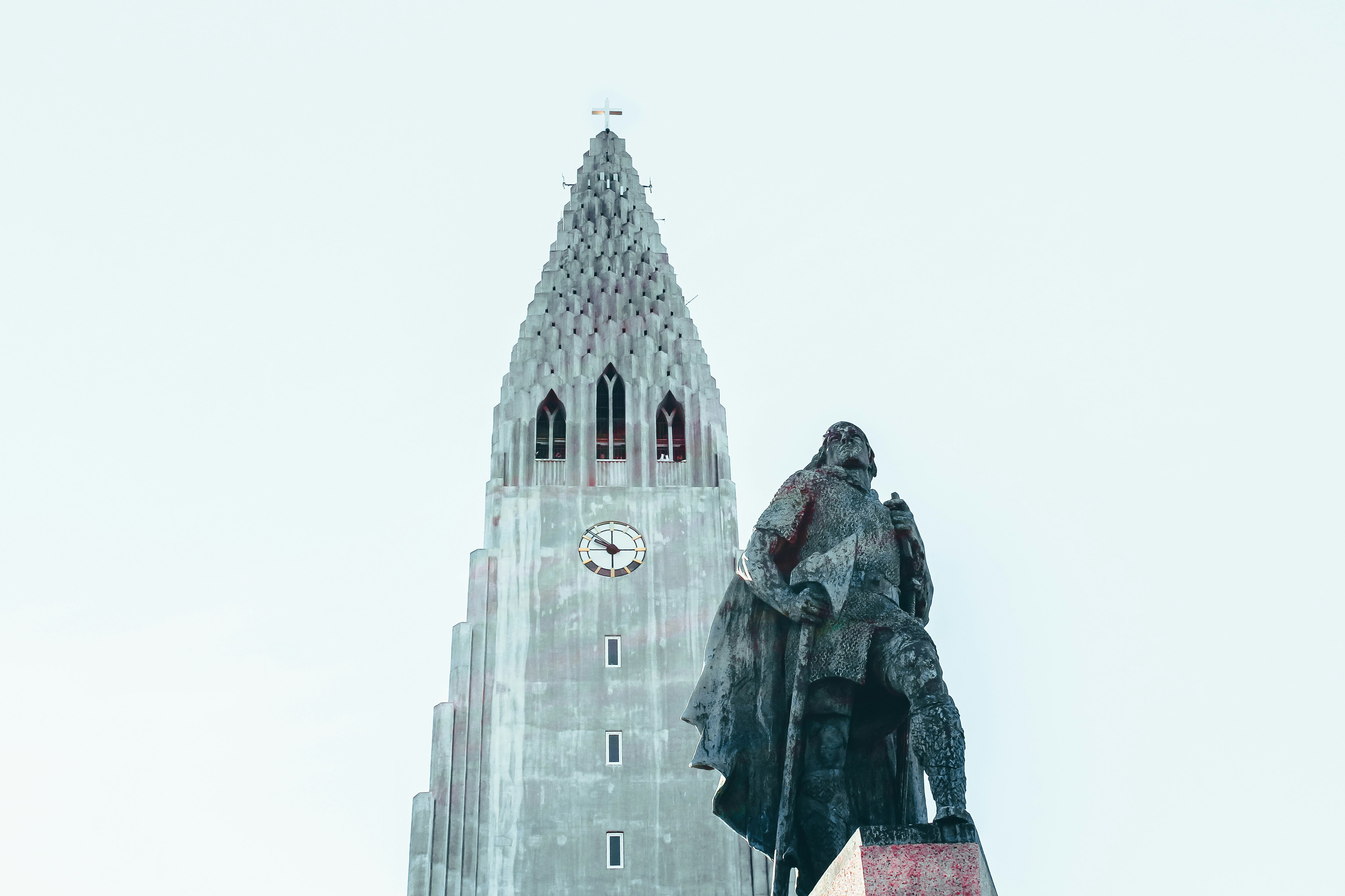 man and woman standing on top of building